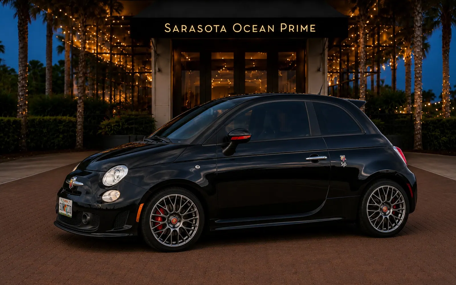 Black 2016 Fiat 500 Abarth parked outside Sarasota Ocean Prime in the evening