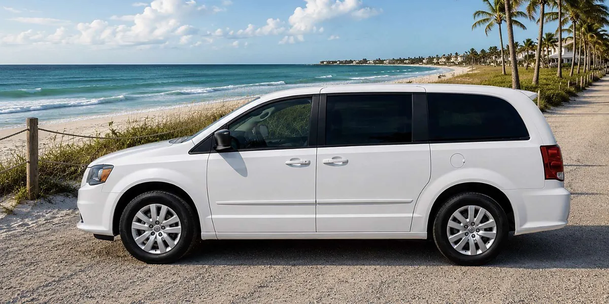 White 2023 Chrysler Voyager LX minivan parked by a Gulf Coast beach