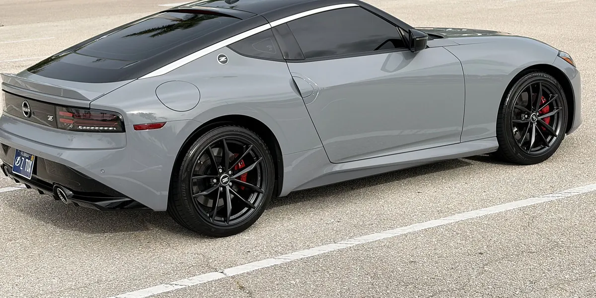 Rear three-quarter view of the gray Nissan Z Performance in a parking lot